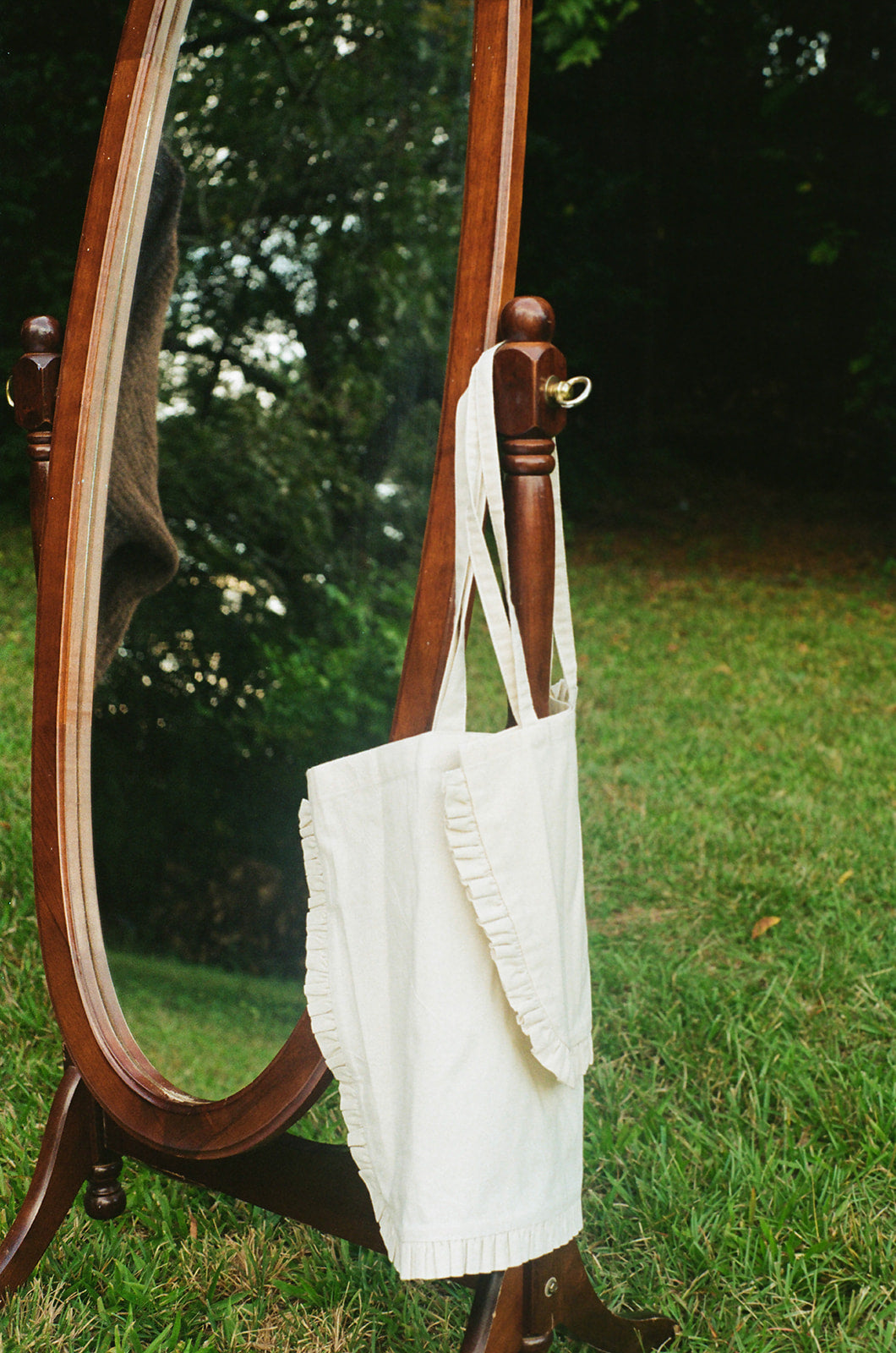 100% Cotton Handmade Ruffle Canvas Totes hanging on vintage mirror outside