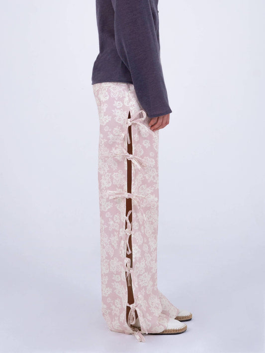 pink floral pants with side slits that have bow tie closures