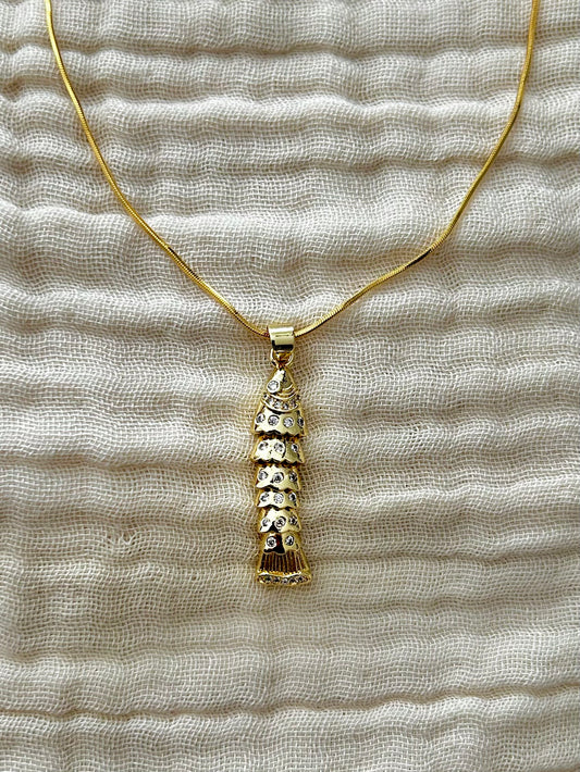 Gold necklace with a textured pendant on a textured beige fabric background

Unique Articulate Fish Design Pendant Necklace

Pendant

Material: Brass, 24K&nbsp;Gold Filled, Cubic Zirconia&nbsp;

Size: 7.9mm x 34.8mm x 5.1mm&nbsp;



Chain

Material: 24K Gold Plated

Style: Cocoon Chain

Length: 18 Inches Width: 0.8mm

Clasps: Spring Ring