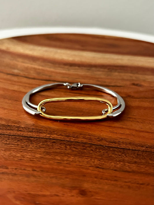 Gold and silver bracelet on a wooden surface

Designed in California

18K Gold Plating&nbsp;

Stainless Steel Silver Plating&nbsp;

Pendant Size (inch):0.65in

Chain Length (inch):6.29in

Lead-free

Nickel-safe

Hypoallergenic

Water Resistant