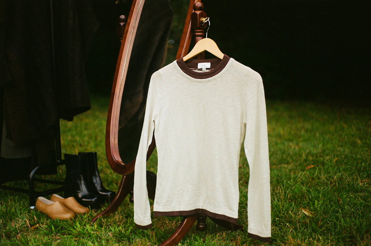 Sage green and brown cotton double layer sweater top displayed outdoors
